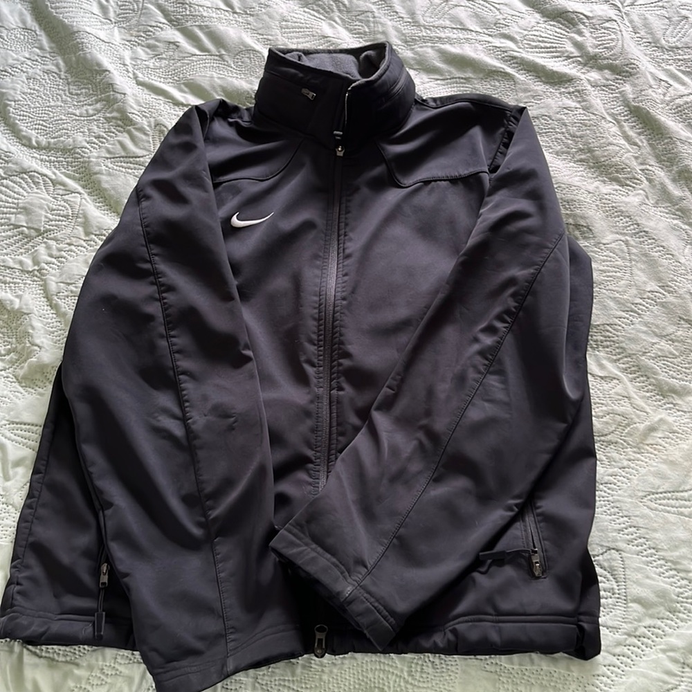 Black Nike athletic windbreaker. Small Nick on right arm, overall good condition